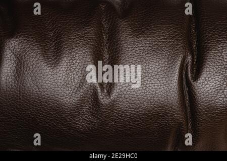 Dark brown shiny leather textured background, abstract Stock Photo