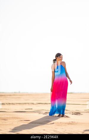 beautiful young african woman wearing a colorful dress, smiling and having fun outdoor, summer holiday concept Stock Photo
