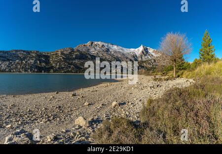 beautiful image of the cuber reservoir with snow in the mountains Stock Photo
