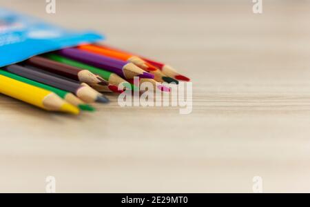 Colored pencils in a box on the table. Stock Photo