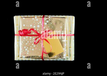 Gifts in wrapping paper and tied with a red ribbon. Stock Photo