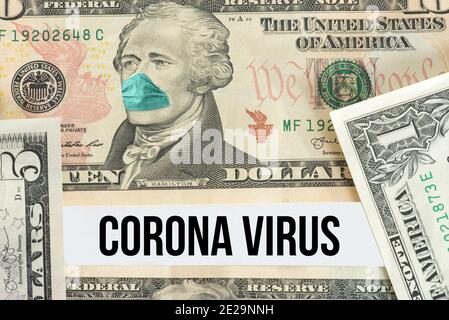 Dollar bill, protective mask and coronavirus Stock Photo