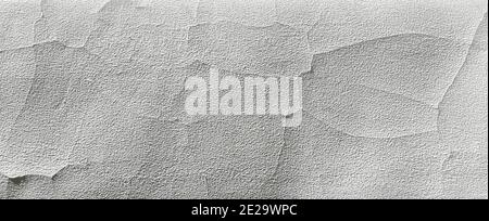Cracking and peeling white paint on old rough wall texture abstract background banner Stock Photo