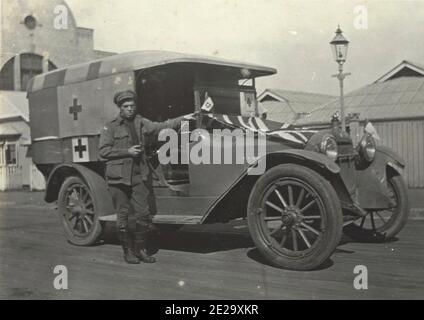 Vintage photograph from the first world war showing red cross ambulance and the driver. Stock Photo