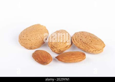 Three almond nuts in shells two un shelled. Stock Photo