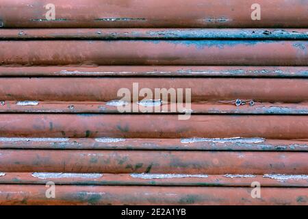 Old burgundy metal door close to use as wallpaper Stock Photo