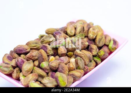 Fresh raw peeled pistachios isolated on white background Stock Photo
