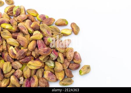 Fresh raw peeled pistachios isolated on white background Stock Photo
