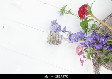 bouquet of dry flowers and potpourri in a Wood plate on a white table. High quality photo Stock Photo