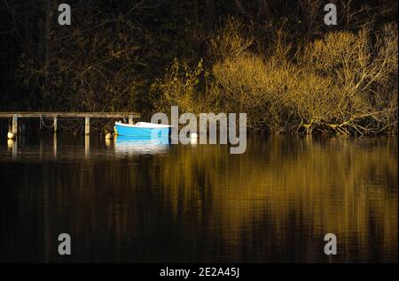 A romantic picture of a turquoise boat on the Dieksee in Bad Malente-Gremsmühlen in Northern Germany. Stock Photo