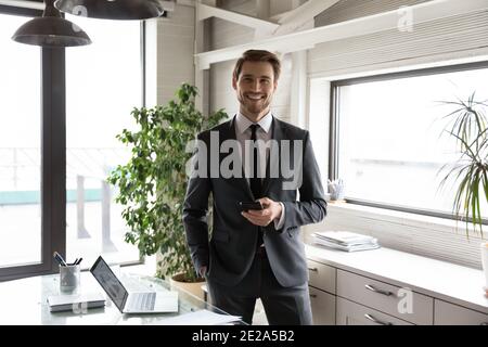 Portrait of smiling young businessman posing in office Stock Photo