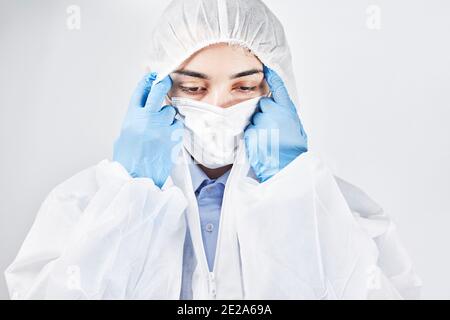 Doctor taking off personal protective equipment in hospital Stock Photo ...