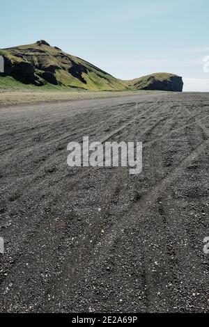 tyre tracks in the black sand landscape of Mýrdalssandur near Vik south Iceland - minimal Iceland empty summer landscape Stock Photo