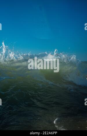 Breaking Waves and spray, white water and light reflecting on the surface of the moving water Stock Photo