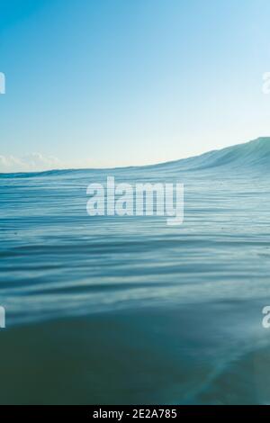 Breaking Waves and spray, white water and light reflecting on the surface of the moving water Stock Photo