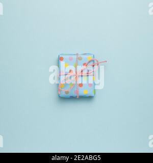 Blue gift box on sky blue background. flat lay, top view, copy space Stock Photo