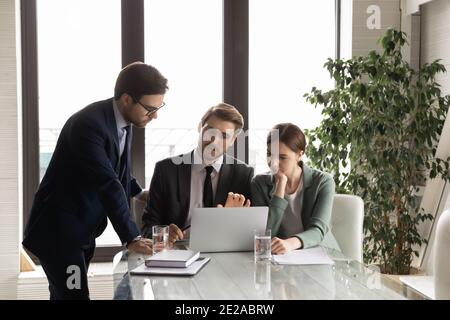 Diverse businesspeople work online on laptop at meeting Stock Photo