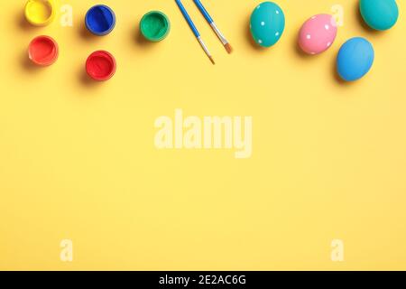 Easter eggs paint and brush on a yellow background. Stock Photo