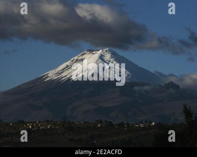 Panorama view of stratovolcano Cotopaxi white snow capped volcanic mountain seen from Latacunga Ecuador in South America Stock Photo