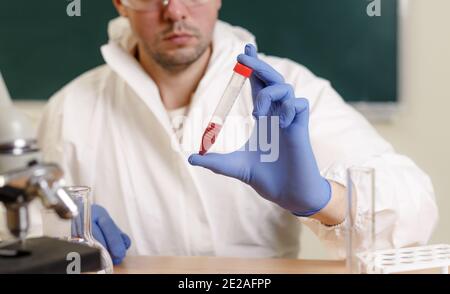 A chemist deals with the study of blood in laboratories. Stock Photo