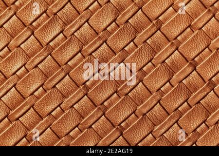 Texture of dark orange leather background with wicker pattern, macro. Abstract backdrop from modern decorative copper textile with diagonal lines. Stock Photo