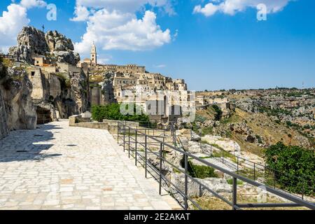 Scenic pedestrian walkway on the edge of Gravina at Sassi di Matera historic district, Basilicata, Italy Stock Photo