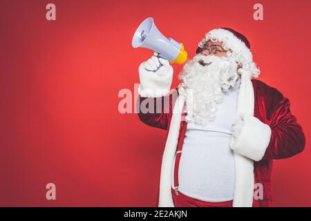 Cheers. Modern Stylish Santa Claus In Red Fashionable Suit And Cowboys Hat  On Dark Background. Looks Like A Rockstar. New Year And Christmas Eve,  Celebration, Holidays, Winters Mood, Fashion. Stock Photo, Picture