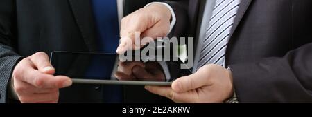 Two businessmen are looking at digital tablet Stock Photo
