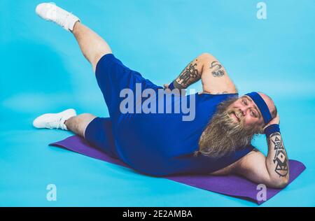 Hipster man with tattoos doing sport and exercises in the morning Stock Photo