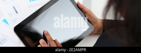 Businesswoman using touchpad while working in office Stock Photo