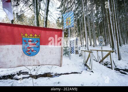 13 January 2021, Hessen, Michelstadt: A Hessian (l) and a Bavarian flag (M  o) each fly at the 