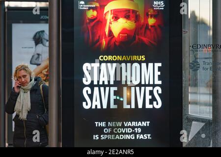 Edinburgh, Scotland, UK. 13 January 2021. Views of virtually empty Princes Street in Edinburgh with Covid-19 health warning displays on bus shelters. Almost all shops have ceased click and collect services so very few shoppers are out during lockdown. Iain Masterton/Alamy Live News Stock Photo