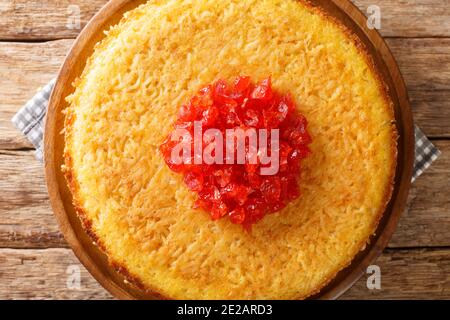 Persian Savory Saffron Cake Tahchin closeup in the plate on the table. Horizontal top view from above Stock Photo