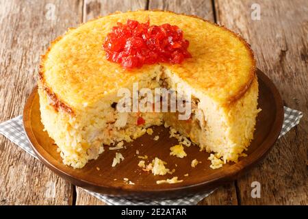 Tahchin or tah-chin, is an Iranian rice cake primarily consisting of rice, yogurt, saffron, and eggs stuffed with chicken fillets closeup in the plate Stock Photo