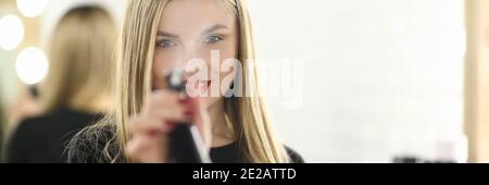 Positive delighted longhaired woman posing on camera Stock Photo