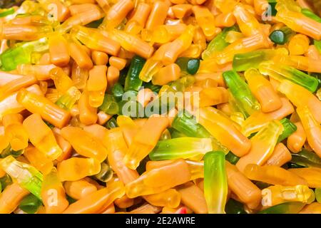 Bright yellow and green marmalade chewing candies in the form of bottles from under the cola. Sweet beautiful delicacy made from gel fruit juices Stock Photo