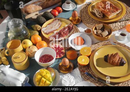 brunch with artichokes mussels croissants fruits brocoli feta salad ham bread and many other food and drink Stock Photo