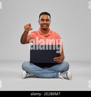 happy indian man with laptop computer Stock Photo