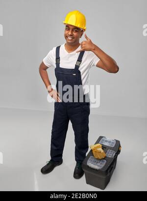 happy worker or builder making phone call gesture Stock Photo