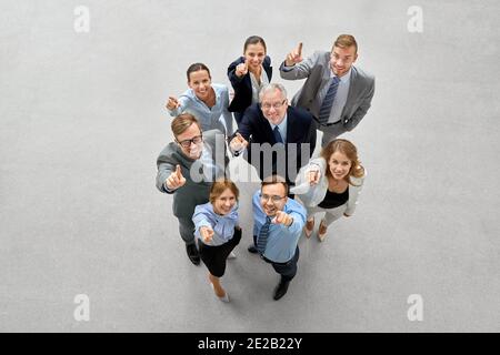 business people pointing fingers up to camera Stock Photo