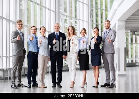 business people showing thumbs up at office Stock Photo