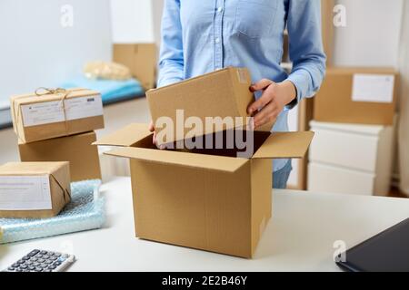 woman packing parcel boxes at post office Stock Photo
