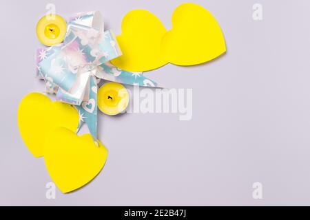 Small festive moments on ultimate gray. Scented illuminating candles and hearts to enhance the celebration. Stock Photo