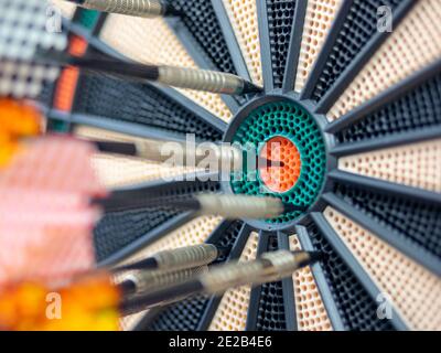 Dart in bulls eye close up image Stock Photo