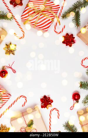 Happy New Year vertical orientation banner. Striped red gift boxes with golden and red bows on a white background. Stock Photo