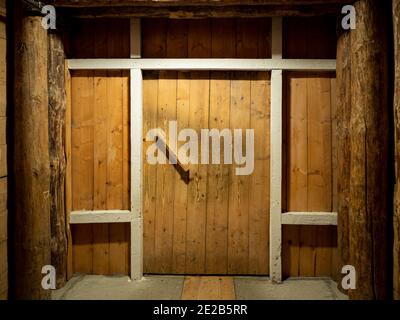 Wooden corridor with door in the salt mining caves. Stock Photo