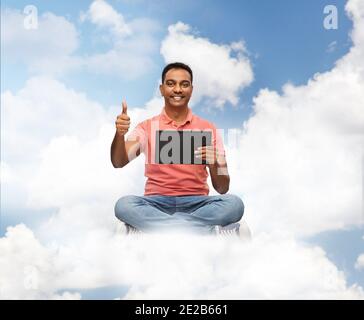 happy indian man with tablet pc showing thumbs up Stock Photo