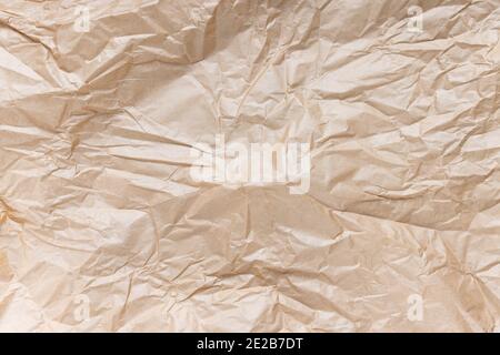 Crumpled used brown kraft paper texture background Stock Photo