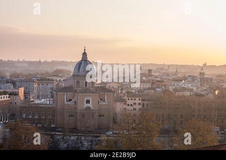 View down onto Rome, Italy, from Trastevere at sunrise.  Church of San Giovanni Battista dei Fiorentini on the River Tiber in the foreground Stock Photo