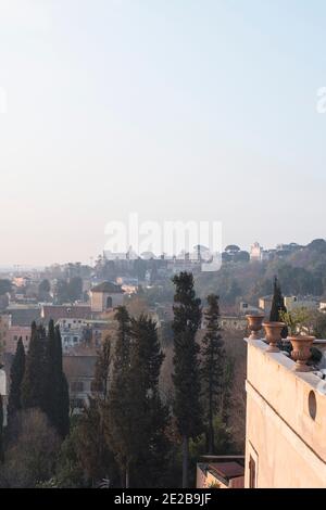 View across the Janiculum Hill in Trastevere, Rome, Italy, over rooftops and pencil Cypresses in late winter Stock Photo